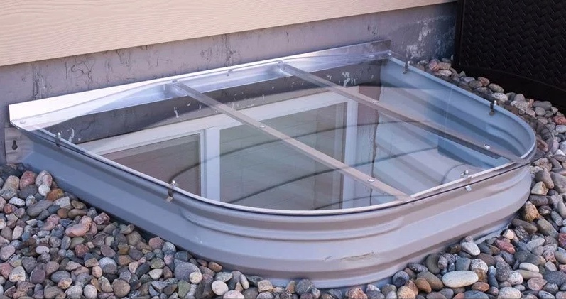 A plastic window well cover.